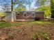 Backyard of a cozy brick home with mature trees and a wood storage shed at 233 Banberry Se Dr, Atlanta, GA 30315