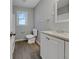 Bathroom featuring modern vanity, toilet, window, and towel rack at 233 Banberry Se Dr, Atlanta, GA 30315
