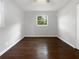 Cozy bedroom featuring hardwood floors, neutral paint and a large window providing natural light at 233 Banberry Se Dr, Atlanta, GA 30315