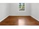 Charming bedroom with beautiful hardwood floors and bright natural light from the window at 233 Banberry Se Dr, Atlanta, GA 30315