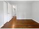 Bright bedroom with hardwood floors, neutral paint, closet space, and an open door into the hallway at 233 Banberry Se Dr, Atlanta, GA 30315