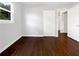 Bedroom featuring hardwood floors, natural light, closet space, and an open door into the hallway at 233 Banberry Se Dr, Atlanta, GA 30315