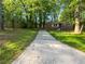 View of the home from driveway framed by mature trees in yard, showing facade, foundation, and mailbox at 233 Banberry Se Dr, Atlanta, GA 30315