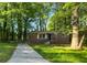 Charming brick home featuring a well-maintained lawn and a concrete driveway, surrounded by mature trees at 233 Banberry Se Dr, Atlanta, GA 30315