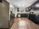 Modern kitchen with stainless steel appliances, dark cabinets, granite countertops, and wood-look flooring at 233 Banberry Se Dr, Atlanta, GA 30315