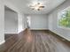 Spacious living room boasts wood-look flooring, a ceiling fan, and neutral walls with access to other rooms at 233 Banberry Se Dr, Atlanta, GA 30315