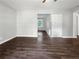 Open-concept living room offers wood-look floors, neutral walls, and a view into other rooms at 233 Banberry Se Dr, Atlanta, GA 30315