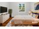 Staged main bedroom featuring a large window and light-colored furniture, providing a relaxing space at 233 Banberry Se Dr, Atlanta, GA 30315