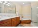 Bright bathroom featuring a double vanity, soaking tub, and glass enclosed shower at 77 Peachtree Ne Pl # 107, Atlanta, GA 30309