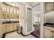 Charming butler's pantry featuring glass-front cabinets, dark countertops, and decorative tile backsplash at 77 Peachtree Ne Pl # 107, Atlanta, GA 30309