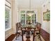 Elegant dining room with hardwood floors, chandelier, and large windows providing natural light at 77 Peachtree Ne Pl # 107, Atlanta, GA 30309