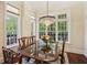 Formal dining area with a grand chandelier and an abundance of natural light from the large windows at 77 Peachtree Ne Pl # 107, Atlanta, GA 30309
