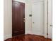 Apartment front door featuring hardware and dark wood, complemented by the hardwood floors inside at 77 Peachtree Ne Pl # 107, Atlanta, GA 30309