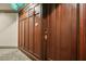 Apartment front door featuring rich wood paneling, hardware, and an 'Exit' sign overhead in hallway at 77 Peachtree Ne Pl # 107, Atlanta, GA 30309