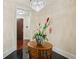 Chic foyer with black tile flooring, flower arrangement on table, and a modern chandelier at 77 Peachtree Ne Pl # 107, Atlanta, GA 30309