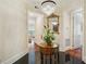 Elegant foyer featuring black tile floors, mirrored table with chandelier, and light colored walls at 77 Peachtree Ne Pl # 107, Atlanta, GA 30309