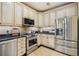 Well-equipped kitchen with stainless steel appliances, granite countertops, and mosaic tile backsplash at 77 Peachtree Ne Pl # 107, Atlanta, GA 30309