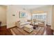 Cozy living room with a neutral palette, sectional sofa, area rug, and natural light from a window at 77 Peachtree Ne Pl # 107, Atlanta, GA 30309