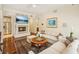 Bright living room features hardwood floors, fireplace with TV, comfortable seating, and modern lighting at 77 Peachtree Ne Pl # 107, Atlanta, GA 30309