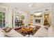 Elegant living room with fireplace, large sofas, and seamless access to the dining area and kitchen at 77 Peachtree Ne Pl # 107, Atlanta, GA 30309