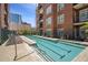Upscale community pool with lounge chairs and landscaping at 77 Peachtree Ne Pl # 107, Atlanta, GA 30309