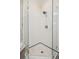 Close-up of a glass-enclosed shower with white tile and black trim at 77 Peachtree Ne Pl # 107, Atlanta, GA 30309