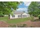 Back of home with screened in porch and large windows overlooks a sprawling lawn at 1675 Bookhout Dr, Cumming, GA 30041