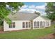 Large backyard features green lawn, screened in porch and large windows at 1675 Bookhout Dr, Cumming, GA 30041