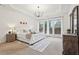 Spacious bedroom with a tray ceiling, neutral tones, large windows, and plush carpet creating a cozy retreat at 1675 Bookhout Dr, Cumming, GA 30041