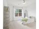 Bright bedroom features neutral carpet, ample natural light, and a charming decorative shelf at 1675 Bookhout Dr, Cumming, GA 30041