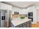 Kitchen with white cabinets, stainless steel appliances, and gray island at 1675 Bookhout Dr, Cumming, GA 30041