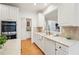 Bright kitchen featuring white cabinetry, tile backsplash, stainless steel appliances, and hardwood flooring at 1675 Bookhout Dr, Cumming, GA 30041