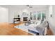 Inviting living room featuring a fireplace, hardwood floors, and ample natural light from large windows at 1675 Bookhout Dr, Cumming, GA 30041