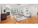 Inviting living room featuring a fireplace, hardwood floors, and ample natural light from large windows at 1675 Bookhout Dr, Cumming, GA 30041