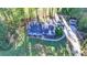 An aerial view of the home with a large front yard, long driveway, and storage shed at 1824 Guardian Way, Lawrenceville, GA 30043