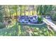 An aerial view of the home with a large front yard and a long driveway at 1824 Guardian Way, Lawrenceville, GA 30043