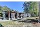 View of the back of the home with a large yard and an outdoor patio at 1824 Guardian Way, Lawrenceville, GA 30043