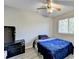 Comfortable bedroom with ceiling fan, window, dark furniture, and serene vibe at 1824 Guardian Way, Lawrenceville, GA 30043