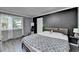 Stylish bedroom with a dark accent wall, modern furnishings, and tranquil atmosphere for relaxation at 1824 Guardian Way, Lawrenceville, GA 30043