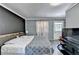Spacious bedroom with a large bed, stylish bedding, and TV, offering a comfortable retreat at 1824 Guardian Way, Lawrenceville, GA 30043