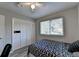 Bedroom with fan, window, gray laminate flooring and closet at 1824 Guardian Way, Lawrenceville, GA 30043