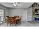 Dining room featuring a ceiling fan, fireplace and outdoor access through French doors at 1824 Guardian Way, Lawrenceville, GA 30043