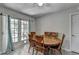 A dining room area featuring a ceiling fan and outdoor access through French doors at 1824 Guardian Way, Lawrenceville, GA 30043