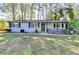 Welcoming single-Gathering home featuring a charming porch and lush green lawn at 1824 Guardian Way, Lawrenceville, GA 30043