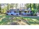 A front view of the home with a well-manicured lawn and landscaping at 1824 Guardian Way, Lawrenceville, GA 30043