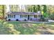 Charming home featuring a well-manicured lawn, classic siding, and inviting front porch perfect for relaxation at 1824 Guardian Way, Lawrenceville, GA 30043