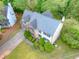Charming home aerial view featuring a well-manicured lawn, driveway, and lush surrounding trees enhancing curb appeal at 2869 Hickory Run Cir, Duluth, GA 30096
