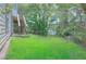 Grassy backyard with a deck and staircase connected to the house at 2869 Hickory Run Cir, Duluth, GA 30096