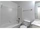 Bathroom with shower-tub combo, white tile, and classic fixtures at 2869 Hickory Run Cir, Duluth, GA 30096