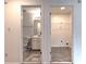View of updated bathroom and closet space with grey tile floors at 2869 Hickory Run Cir, Duluth, GA 30096